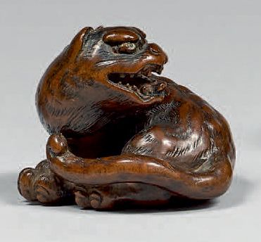 JAPON - Fin de l'époque Edo (1603-1868) Netsuke en bois, tigre assis la tête tournée...