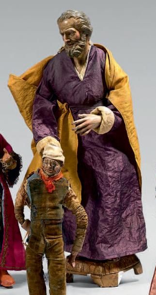null Saint Joseph à la robe violette et à la cape jaune en terre cuite polychrome.
(Polychromie...