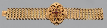 null Bracelet articulé en or jaune 750 millièmes orné au centre d'un motif fleur...