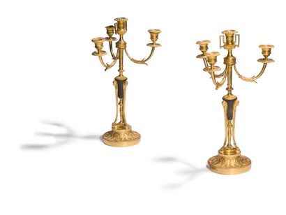 null Pair of patinated and gilt bronze candelabra, with four lights, the shaft in...