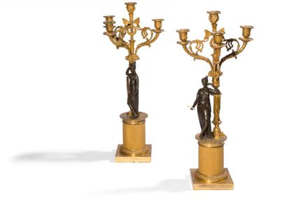 null Pair of four-light patinated and gilded bronze candelabra, decorated with a...