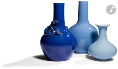 null CHINA - 20th centuryThree
blue enamelled porcelain vases, one of which has a...