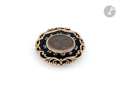 null Oval gilt metal brooch with a compartment containing braided hair surrounded...
