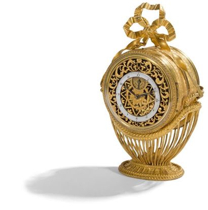 null Rare small double-sided gilt bronze clock forming an alarm clock, with a dial...