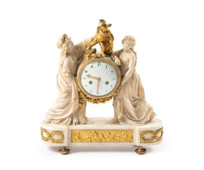 null A clock with vestals in carved white marble and gilded bronze, the antique women...