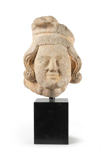 null Limestone corbel carved with a man's head; medium-long wavy hair with curved...