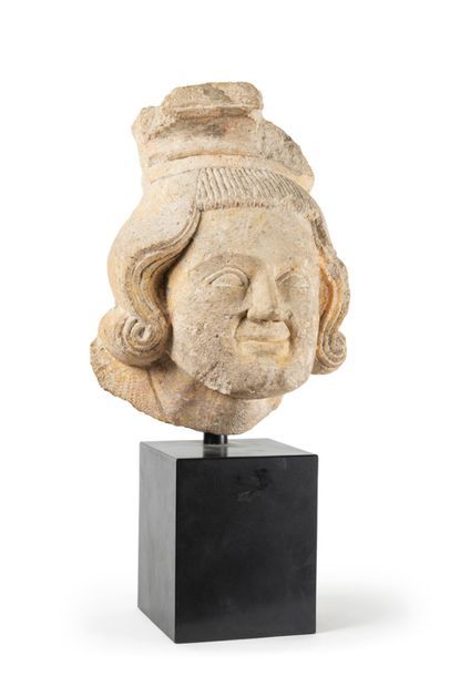 null Limestone corbel carved with a man's head; medium-long wavy hair with curved...