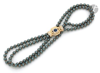 null CHAUMETA necklace of
two rows of hematite balls scaled with gold ferrules, clasp...