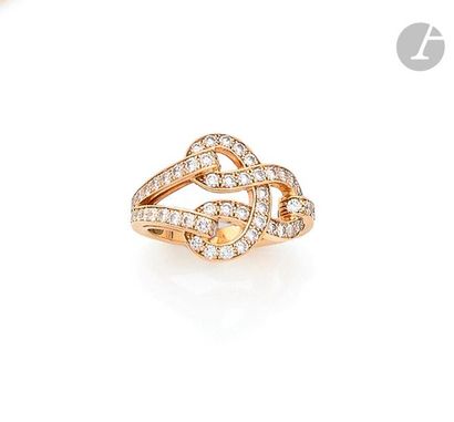 null CARTIERA ring in
18K (750) gold with a knotted buckle pattern set with round...
