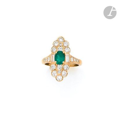 null Ring in 18K (750) gold, set with an oval shaped emerald shouldered with baguette...