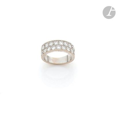 null 18K (750) white gold band ring set with two lines of round brilliant diamonds....