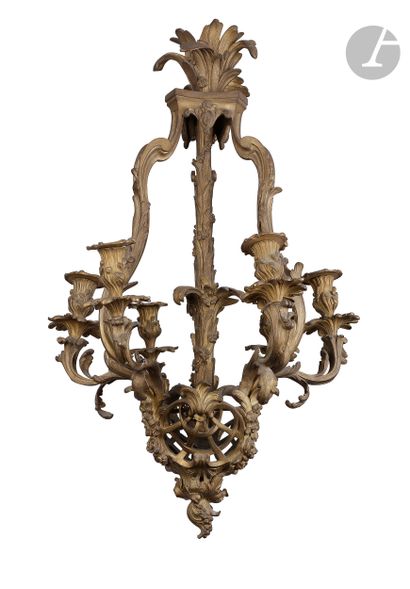 null A gilt bronze chandelier with six lights and rocaille decoration of foliage,...