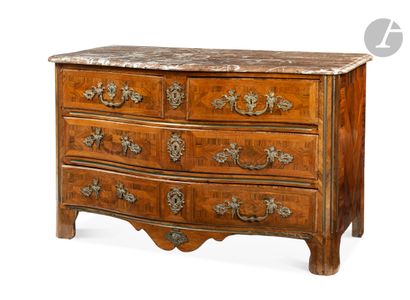 null A rosewood chest of drawers opening to four drawers on three rows, the top of...