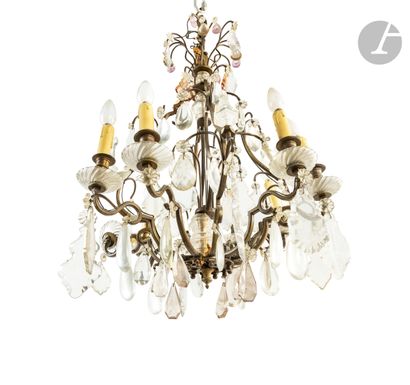 null A bronze and cut and stained glass chandelier with eight lights and pendants...