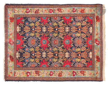 null KARABAGH - Early 20th century.
Carpet decorated with multicolored stylized flowers...