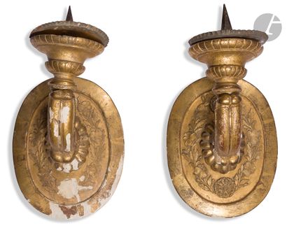 null A pair of gilded wood sconces decorated with stylized foliage and flowers; (accidents...