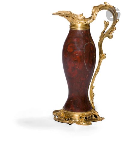 null An ornemental red marble ewer with an ormolu frame decorated with foliage.
Louis...