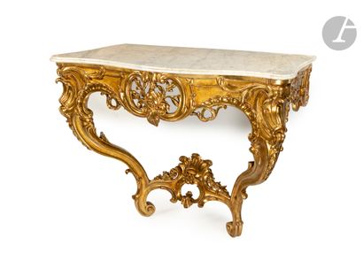 null A giltwood console with openwork foliage and rocaille decoration, the white...