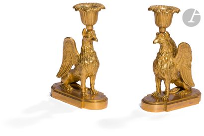 null Pair of ormolu torches featuring griffins, resting on a stepped base.
Louis...