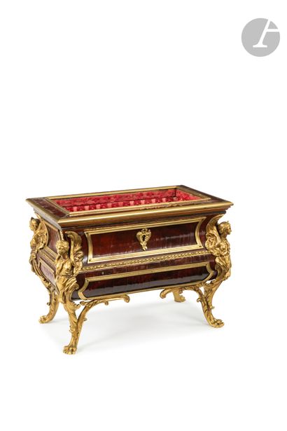 null A small red tortoiseshell veneered and gilt bronze chest of drawers with a drawer...