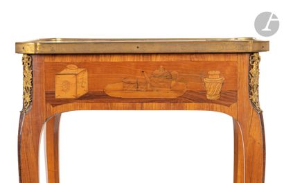null A marquetry writing table with musical instruments, the top resting on a belt...