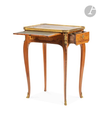null A marquetry writing table with musical instruments, the top resting on a belt...