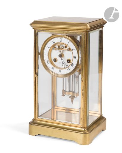 null Cage clock in moulded and gilded brass and glass, the dial with Arabic numerals...