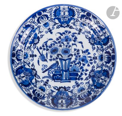 null Delft
Two earthenware plates with blue monochrome decoration of baskets, putti...