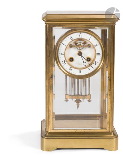 null Cage clock in moulded and gilded brass and glass, the dial with Arabic numerals...