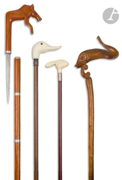 null Lot consisting of four canes (including one sword cane) and two umbrellas. Two...