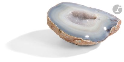 Half agate geode of blue-grey color with...