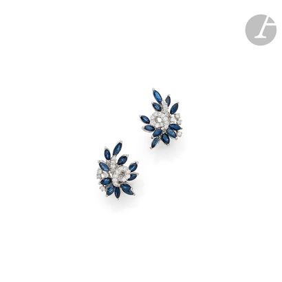 null Pair of 18K (750) white gold ear clips set with round diamonds and navette sapphires....