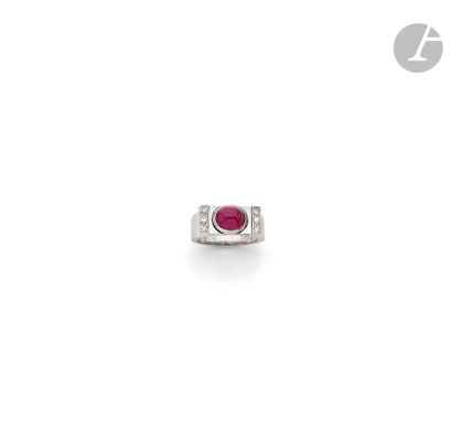 null Platinum signet ring set with an oval cabochon ruby between two lines of 8/8...
