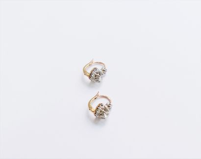  A pair of 18K (750) gold sleeper earrings, each set with 2 diamonds, one old cut,...