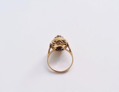  A silver and 18K (750) gold ring set with an orange stone surrounded by rose-cut...