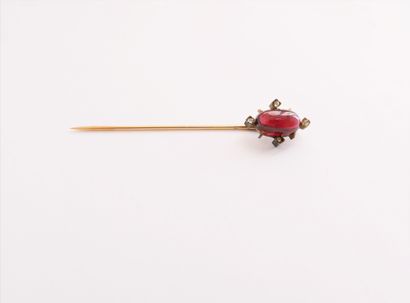 null 18K (750) gold lapel pin set with a cabochon garnet and rose-cut diamonds. French...