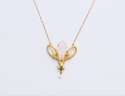 null A two-tone 18K (750) gold necklace, decorated with a stylized floral design...