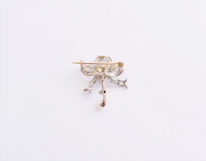  A silver brooch with knotted ribbons set with old cut diamonds and roses, holding...