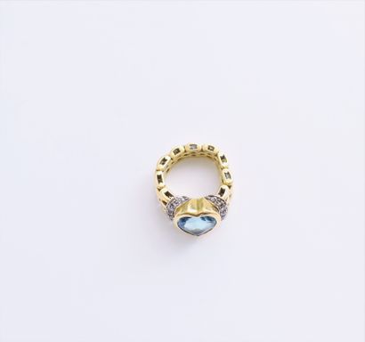 null 18K (750) gold ring with a heart-shaped blue stone set with round brilliant-cut...