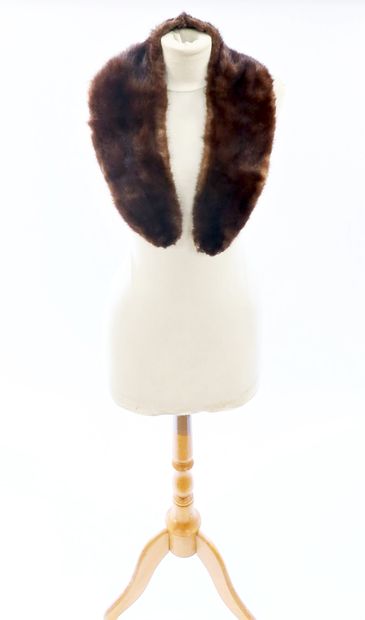 null 3 mink stoles, 2 of which have paws and heads.