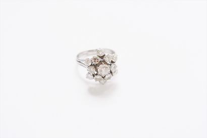 null A platinum ring with a stylized flower, set with round brilliant diamonds. French...