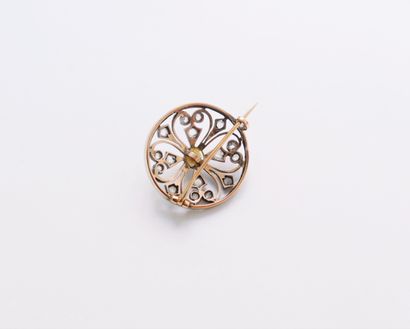  Round silver brooch, openwork, centered with a pearl, set with rose-cut diamonds....