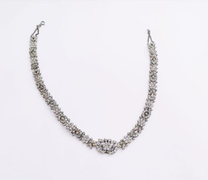 Silver necklace forming a race of flowers,...