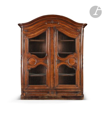 Moulded and carved walnut bookcase opening...