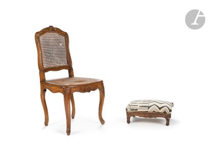 null A moulded and carved beechwood cane chair, decorated with cartouches, foliage...
