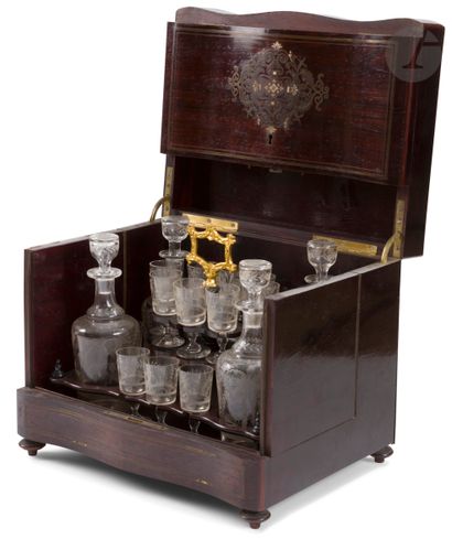 null A rosewood liquor cabinet with sixteen glasses and four decanters (small replacements)....