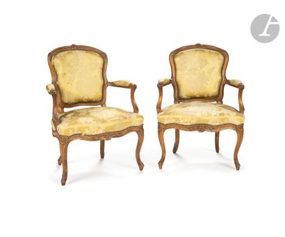 A pair of moulded and carved beechwood armchairs...