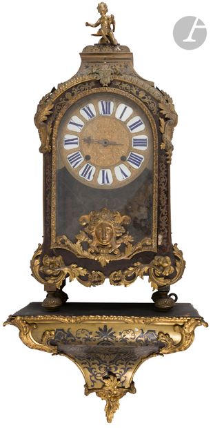 null A brown tortoiseshell and engraved brass cartel decorated with foliage scrolls,...