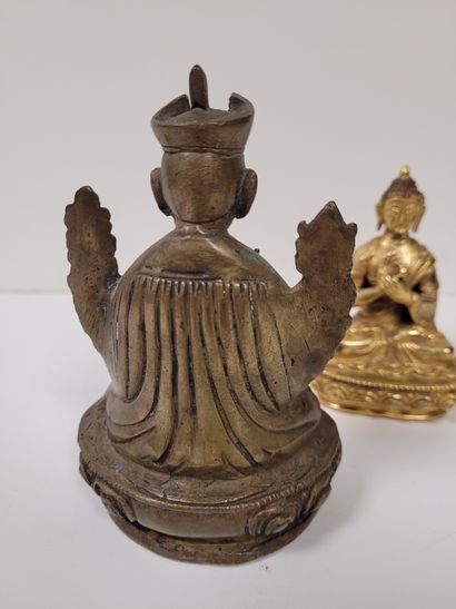 null Two bronze statuettes, Asia, 20th
centuryOne gilded representing Buddha, hands...