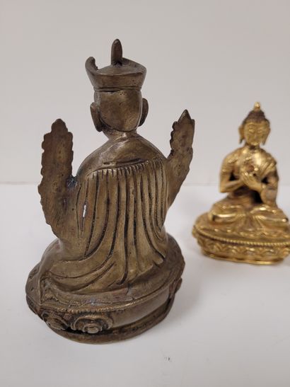 null Two bronze statuettes, Asia, 20th
centuryOne gilded representing Buddha, hands...